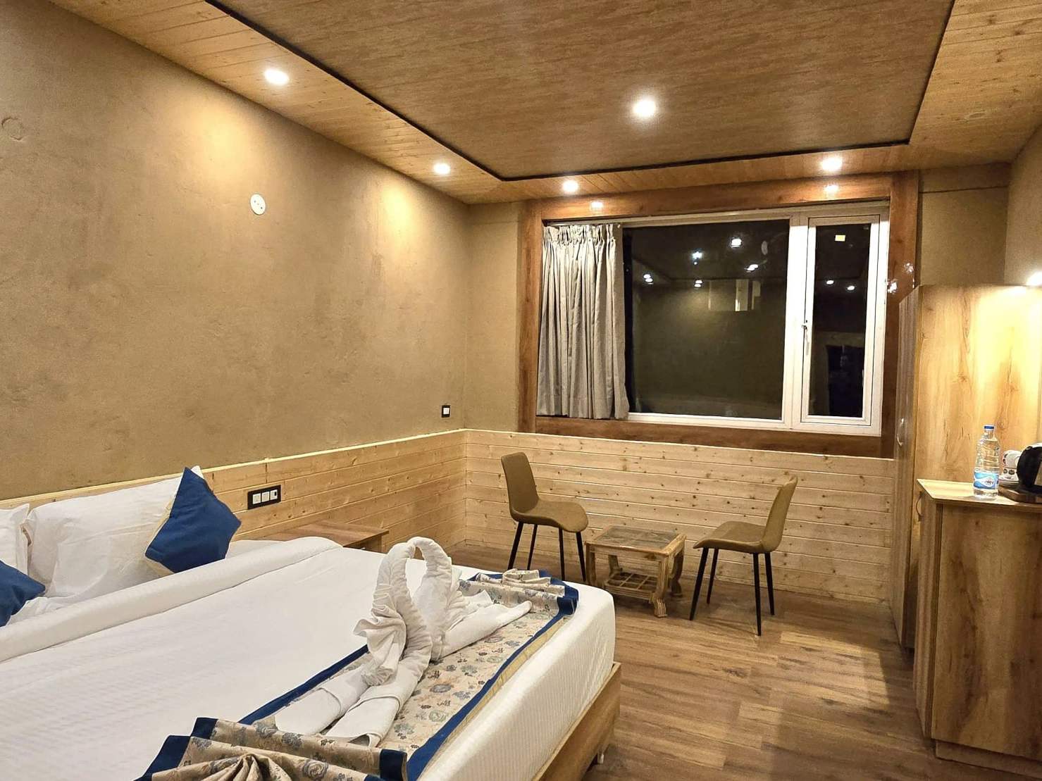 Premium Mud Room: a bed with blue cushions against warm mud-plastered walls