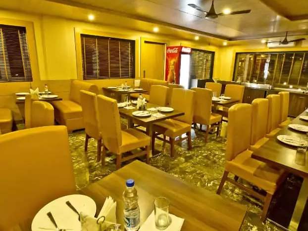 The Quartz restaurant with mustard upholstered chairs and laid tables