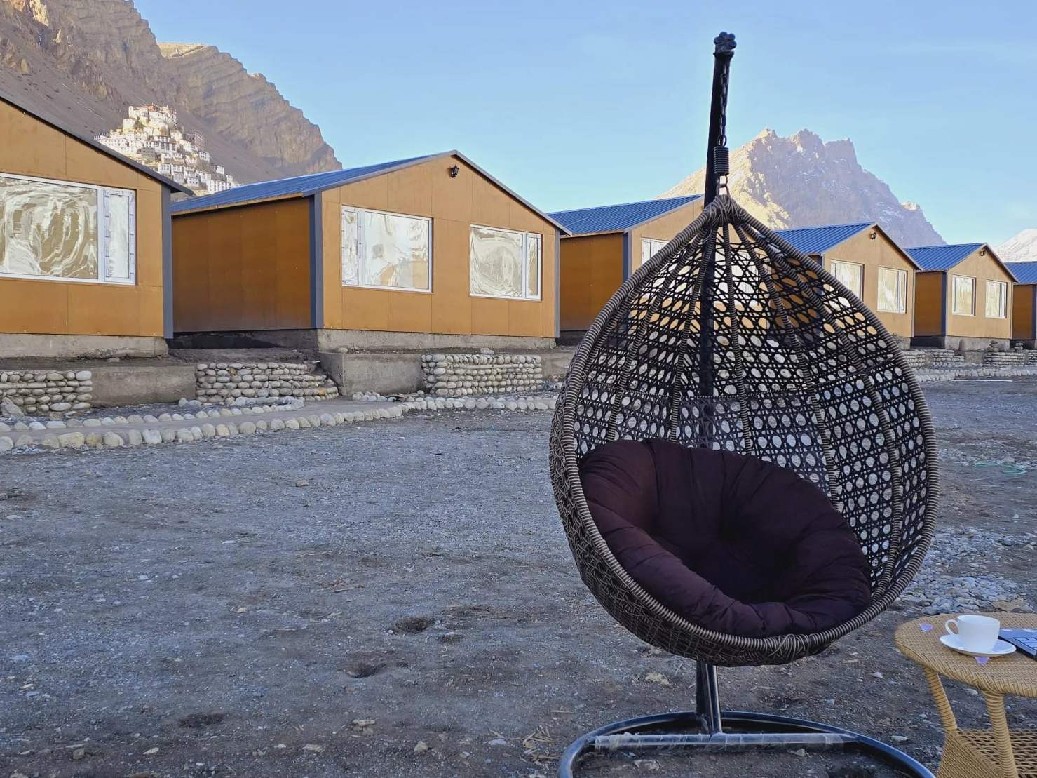 A hanging egg chair outside the cottages