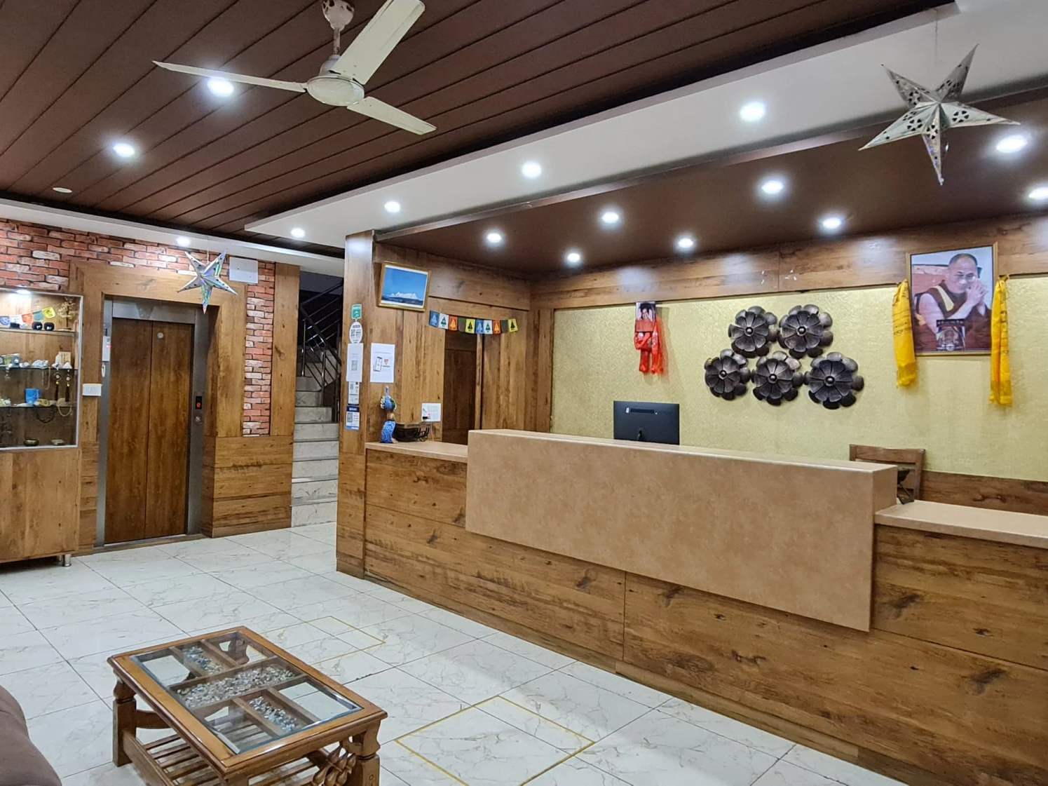 The Buddha House reception, with a wooden desk and Tibetan wall hangings