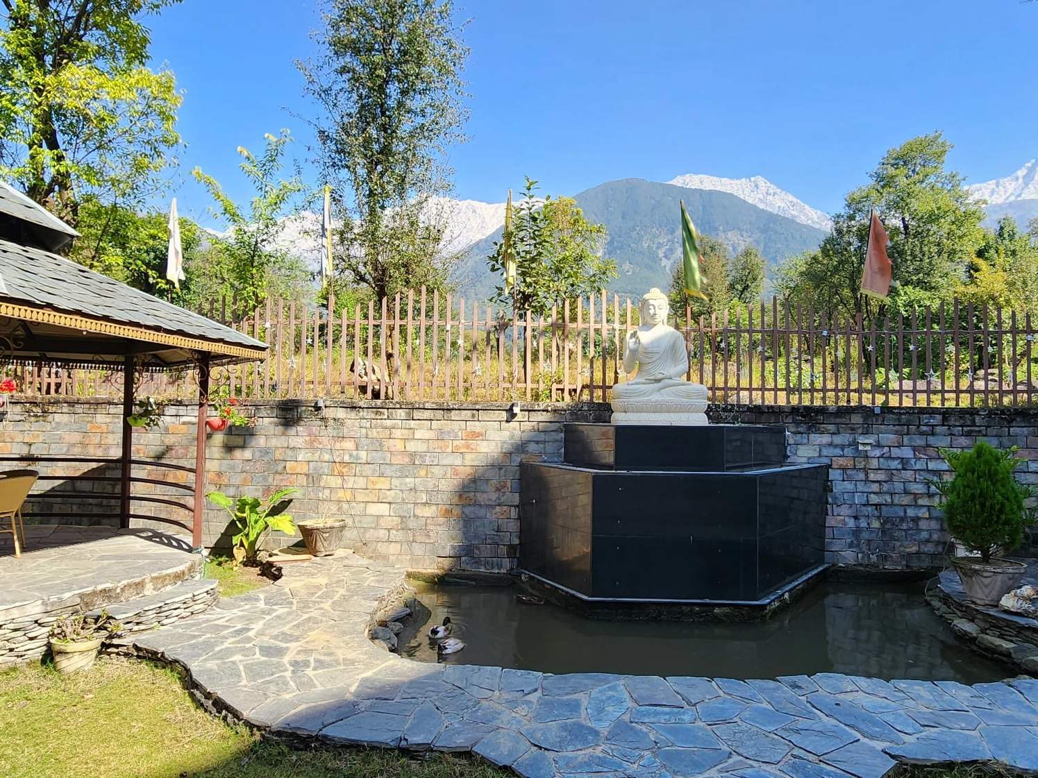 A stone fountain and seating in the Quartz garden