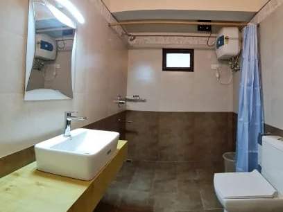 The attached bathroom with a washbasin and shower